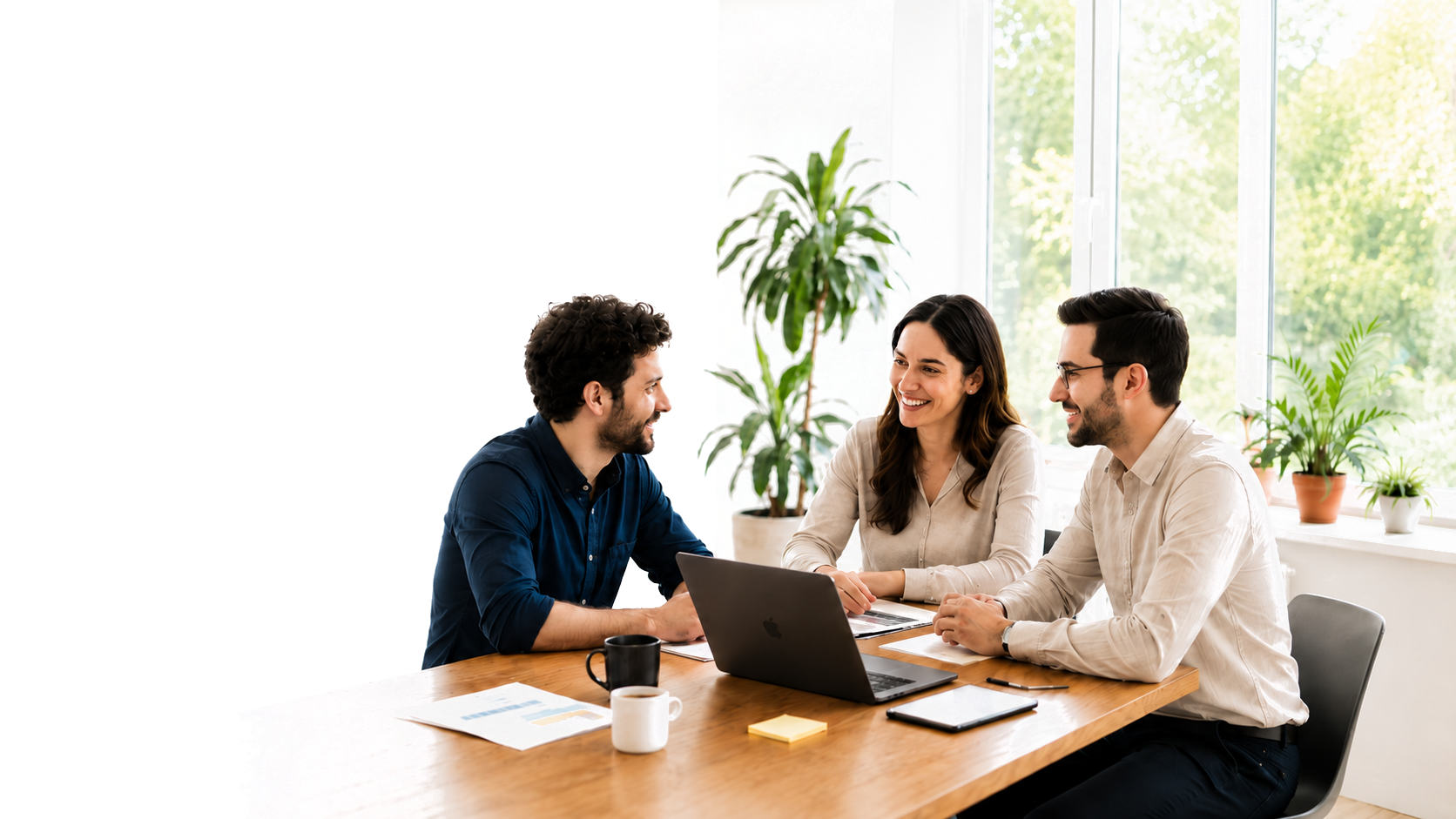 Team collaborating around a laptop